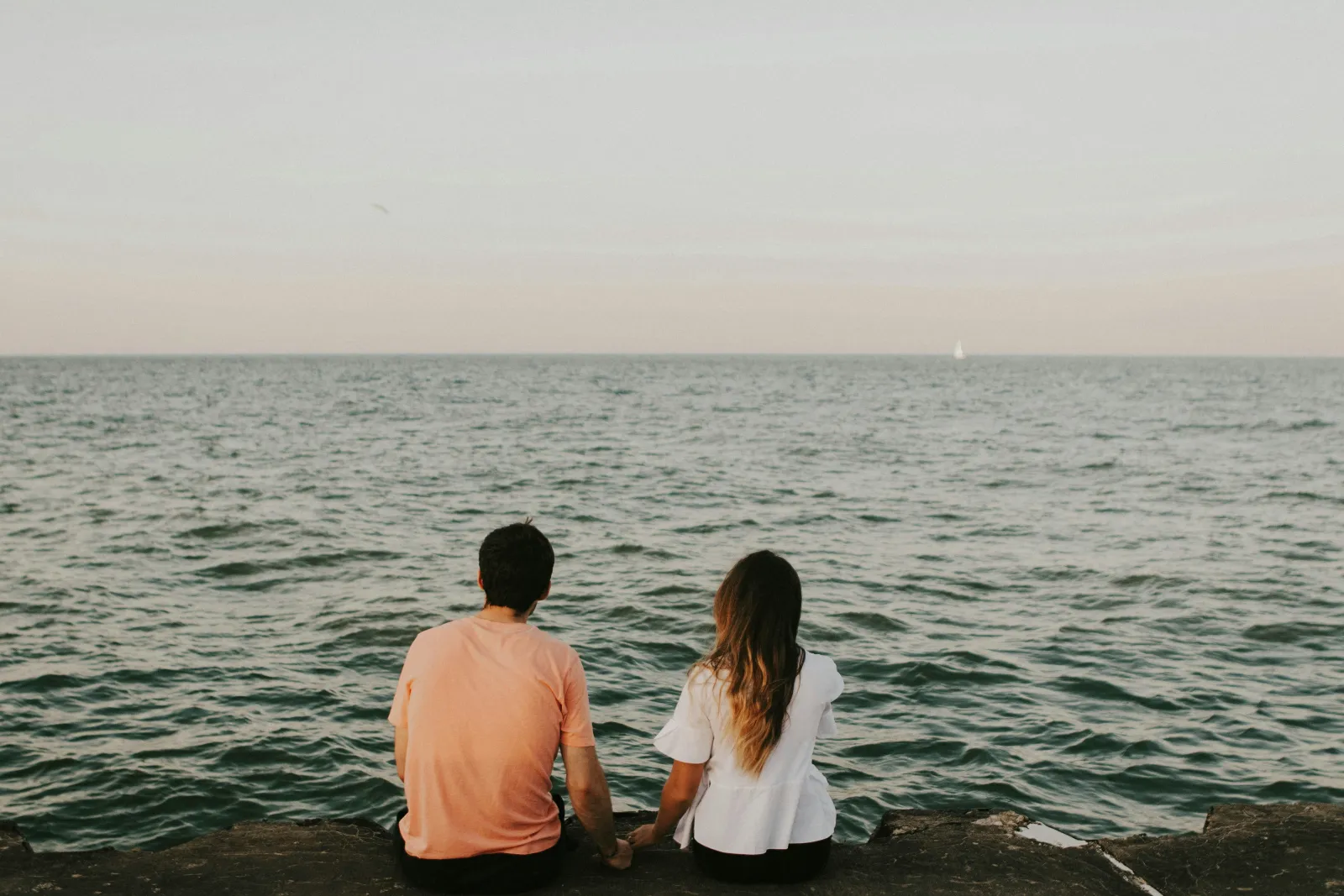 A couple sitting together by the ocean